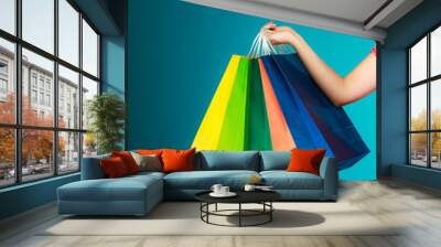 Colorful shopping bags in female hand. Sale retail Wall mural