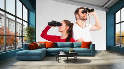 Couple looking through binoculars Wall mural