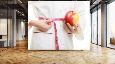 Doctor specialist holding fruit apple measuring waist Wall mural