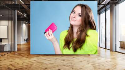 Happy girl with mobile phone in pink cover Wall mural