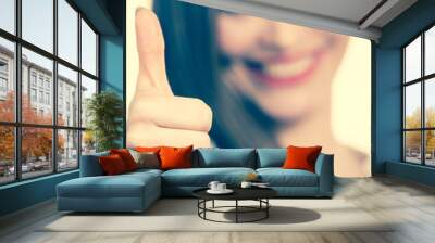 Happy positive brunette woman showing thumb up Wall mural