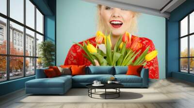 Pretty woman with red yellow tulips bunch Wall mural