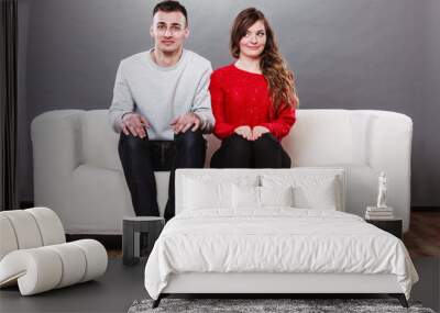 Shy woman and man sitting on sofa. First date. Wall mural