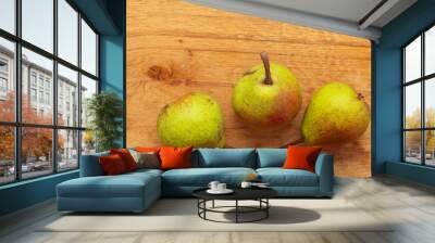 Three pears fruits on wooden table background Wall mural