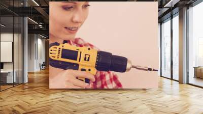 Woman drilling in wall Wall mural