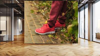 Woman wearing red trainers sportwear shoes Wall mural