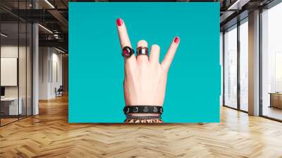 Rock hand sign, female hand punk rock gesture with gold wrist bracelets and finger rings isolated, creative art protest banner, fashion hipster accessories, 3d rendering Wall mural