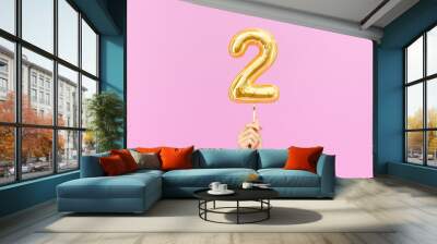 Two year birthday. Female hand holding Number 2 foil balloon. Two-year anniversary background. 3d rendering Wall mural