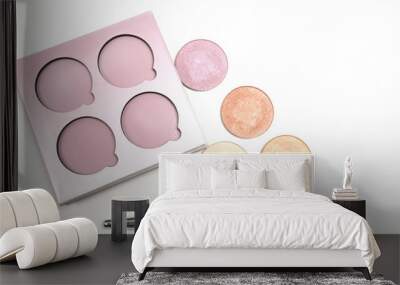 Kit of colorful makeup highlighters with cosmetic brush over a white background Wall mural