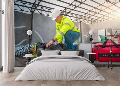 Accident at construction site. Physical injury at work of construction worker. First Aid Help a construction worker who accident at construction site. First Aid Help at accident in constructions work. Wall mural