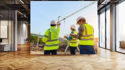 Civil engineer inspects work using radio communication with the management team in the construction area. Wall mural