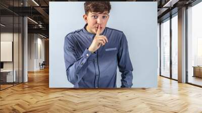 Cheerful guy in a shirt posing for the advertising Wall mural