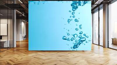 Blue bubbles underwater flowing up to the surface in nature. Blue background with copy space Wall mural