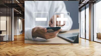 using a smartphone shows icons plus and minus. sign opposite negative positive. concept of a decision to choose plus or minus, comparing pros and cons, versus good and bad Wall mural
