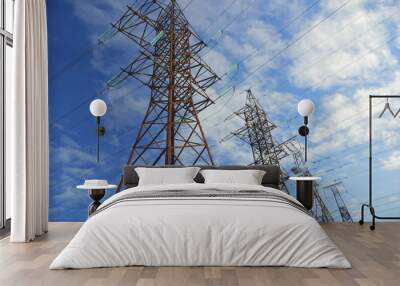 power transmission line pylons with threatening blue clouds background Wall mural