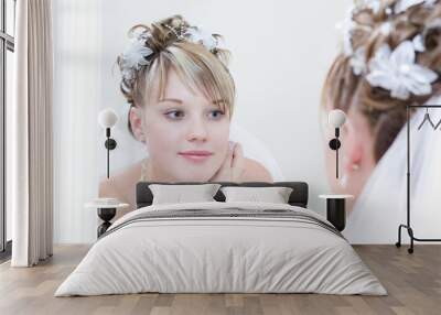 young bride looks into a big mirror Wall mural