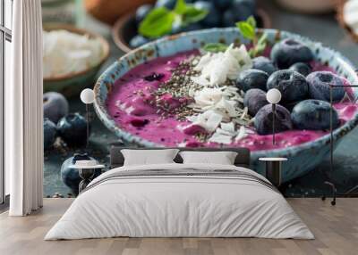 Smoothie bowl filled with blueberry puree and topped with chia, coconut, and more for a healthy start of the day Wall mural