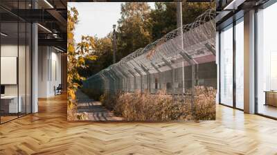 Long fence with barbed wire, the protection of refugees Wall mural