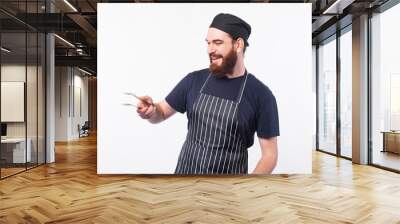 Chef man preparing some meat on bbq over white background. Wall mural