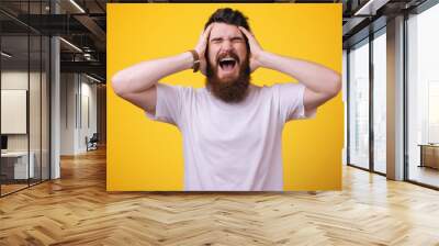 Failed again. Frustrated handsome bearded man hold hands on head and keep eyes closed Wall mural