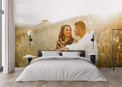 Happy in love couple having fun outdoor in nature at sunset, smiling girl, engagement Wall mural