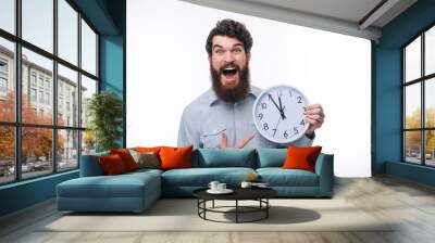 Photo of amazed man screaming and pointing at big watch Wall mural