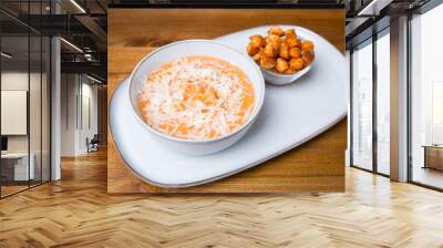 Plate of soup creme with chicken and cheese with crackers Wall mural