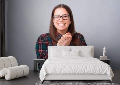 Portrait of cute young woman smiling and looking at the camera. Wall mural