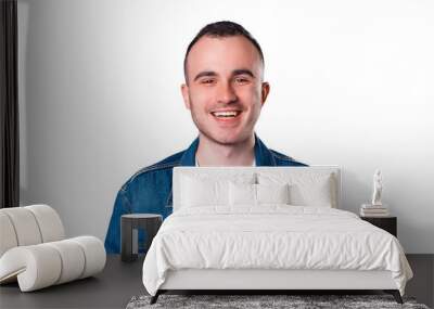 Portrait of smiling handsome young man wearing blue jeans jacket Wall mural