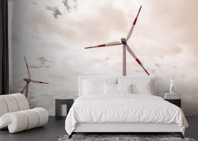 Two white wind turbines in spring time working for energy on a cold cloudy day. Wall mural