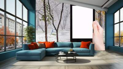 tablet pc and first snowfall in public garden Wall mural