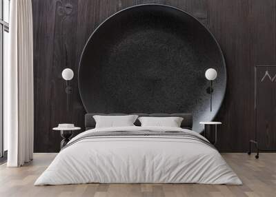 top view of black plate on dark brown table Wall mural