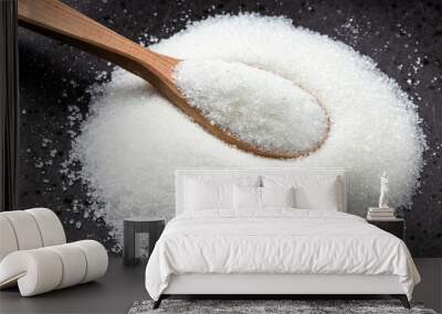 wooden spoon with white refined sugar on black Wall mural