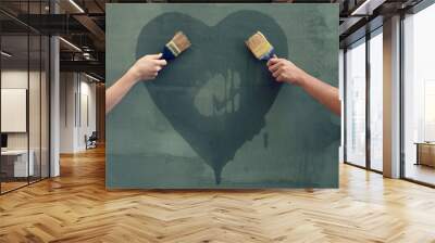 Man and woman painting heart on the concrete wall Wall mural