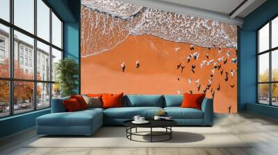 Seagulls fly over the sandy beach. View from above. Sand and waves. Abstract nature landscape background Wall mural