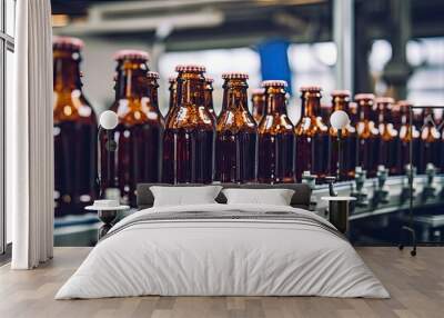 A beverage factory production line with a conveyor belt holding bottles illustrates the food and drink manufacturing process with copy space image. Wall mural