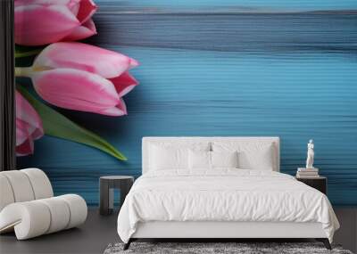 A blue wooden background showcasing two pink Tulips providing ample space for additional images or text Wall mural