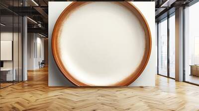 A ceramic plate with a brown circle set on a white background is devoid of any objects with additional space for text or images Wall mural