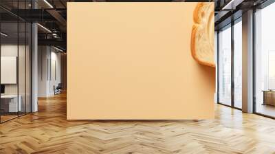 A close up top view of a beautiful big sliced bread on a cream color background perfect for design with copy space image Wall mural