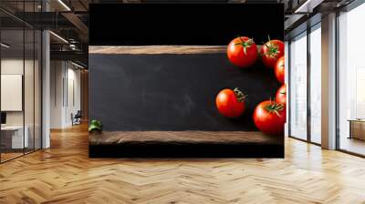 A copy space image featuring sliced tomatoes on a wooden cutting board placed on a black chalkboard with a black background Wall mural