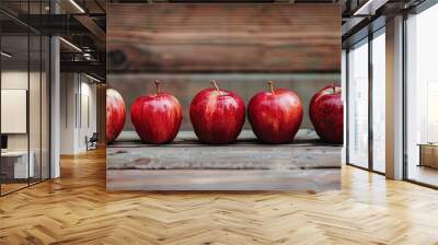 A row of apples on a rustic wooden table with copy space image Wall mural