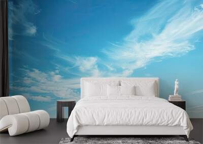 A serene scene of clear blue skies with wispy white clouds peacefully drifting in the airy atmosphere creating a tranquil copy space image Wall mural