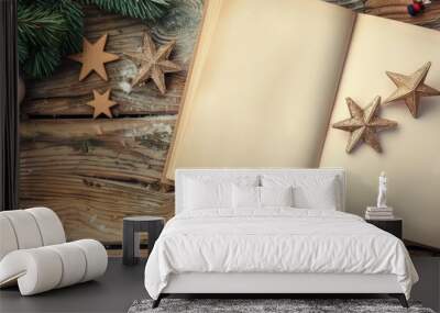 An open blank notebook rests on a vintage wooden table, accompanied by New Year decorations like three stars and toys, creating a charming scene with copy space image. Wall mural