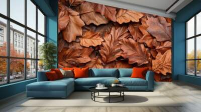 Autumn backdrop on a brown surface with copy space Autumn leaves against a beige background Oak leaves Wall mural