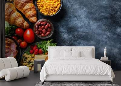 Breakfast is served in the morning on the table with croissant bread croissant cereal bacon ham cheese lettuce beans corn flakes and fruits for a healthy meal Top view with copy space Wall mural