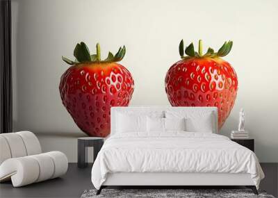 Close up of two strawberries next to each other On the left is a misshapen fruit compared to the typical shape on the right Both are isolated against a simple white background. with copy space image Wall mural