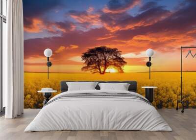 Colorful sky evening sunset and a yellow rapeseed field create a scenic view in this copy space image Wall mural