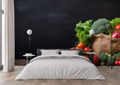 Fresh organic vegetables displayed on a dark table background with a copy space image inside a brown paper bag Wall mural