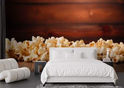 Fresh popcorn kernels scattered on a rustic wooden table creating a contrasting setup against a dark background. with copy space image. Place for adding text or design Wall mural