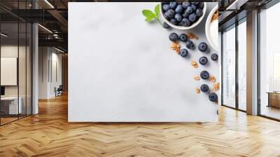 Healthy food concept Breakfast yogurt bowl with granola blueberries and maple syrup on gray background from above with empty space Wall mural